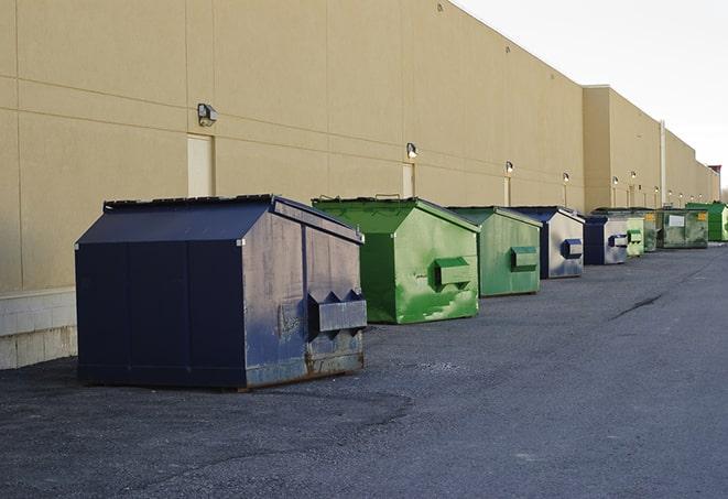 a red construction dumpster placed in front of a building under construction in Cranbury